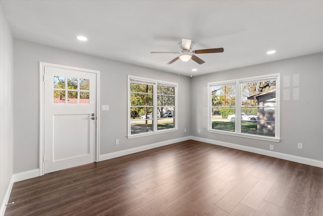 interior space featuring ceiling fan, dark wood-type flooring, and a healthy amount of sunlight