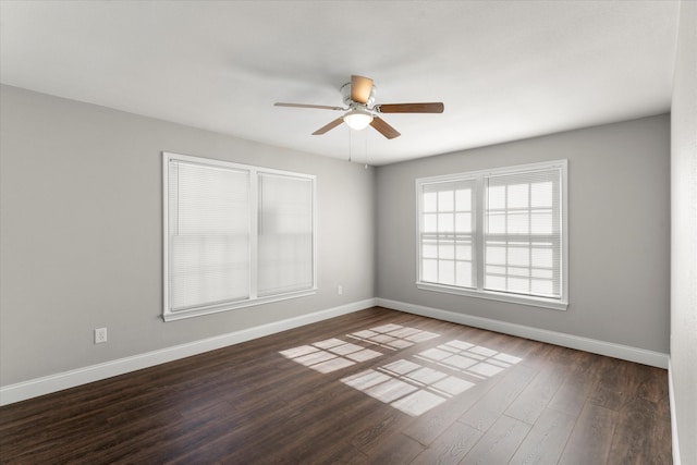 spare room featuring ceiling fan and dark wood-type flooring