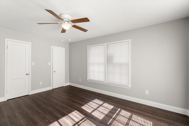 spare room featuring dark hardwood / wood-style flooring and ceiling fan