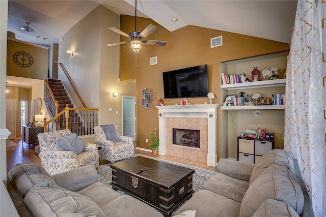 tiled living room with a fireplace, high vaulted ceiling, and ceiling fan