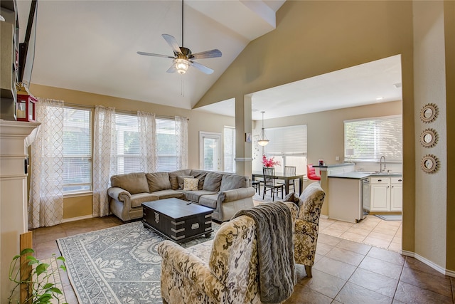 living room with ceiling fan, light tile patterned floors, sink, and high vaulted ceiling