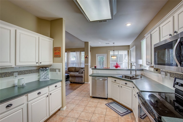 kitchen featuring white cabinetry, sink, and appliances with stainless steel finishes