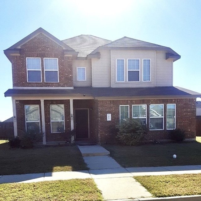 view of front of property with a porch and a front yard