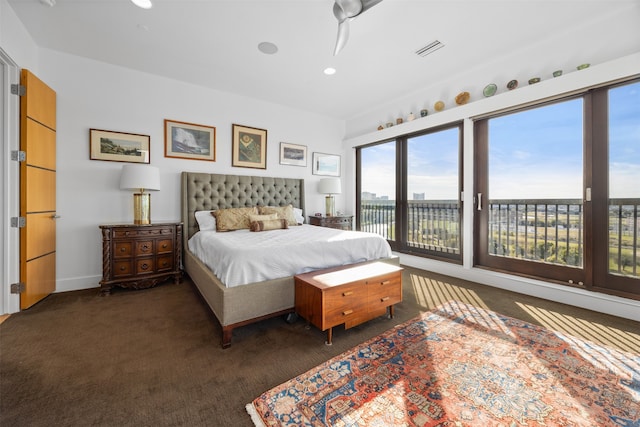 bedroom featuring ceiling fan, dark carpet, and access to outside