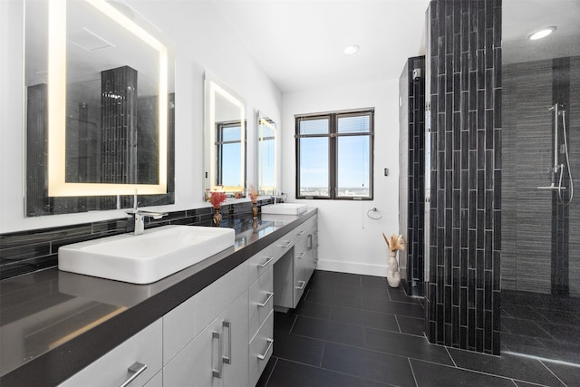 bathroom with tiled shower, vanity, tasteful backsplash, and tile patterned floors