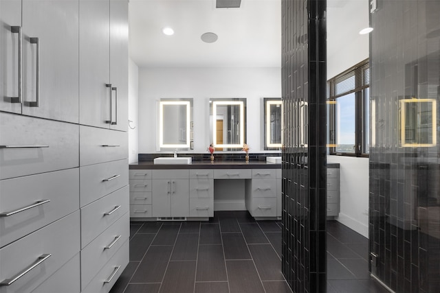 bathroom with vanity and a shower with shower door