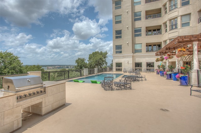 view of pool featuring a pergola, grilling area, and a patio