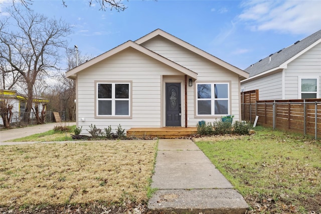 bungalow-style home with a front lawn