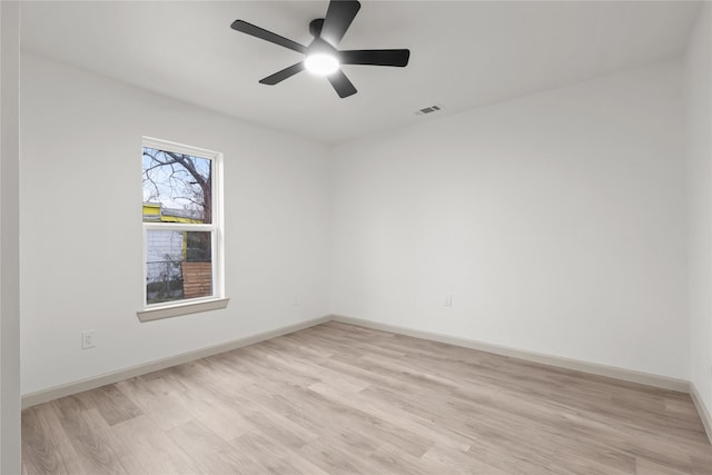 spare room featuring ceiling fan and light hardwood / wood-style floors