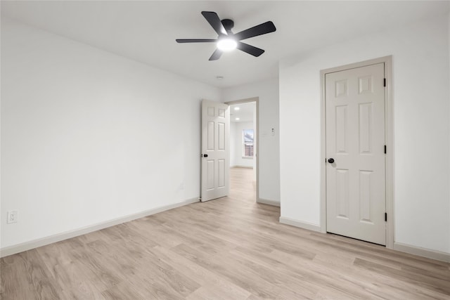 unfurnished bedroom with ceiling fan and light wood-type flooring