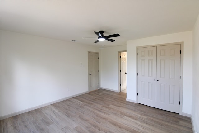 unfurnished bedroom with light wood-type flooring and ceiling fan