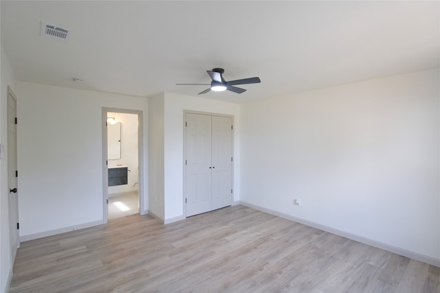 unfurnished bedroom featuring ceiling fan, a closet, and light hardwood / wood-style floors