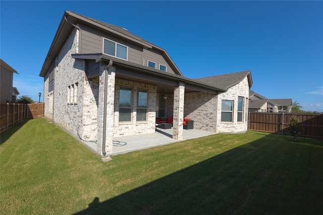 rear view of house featuring a lawn and a patio area