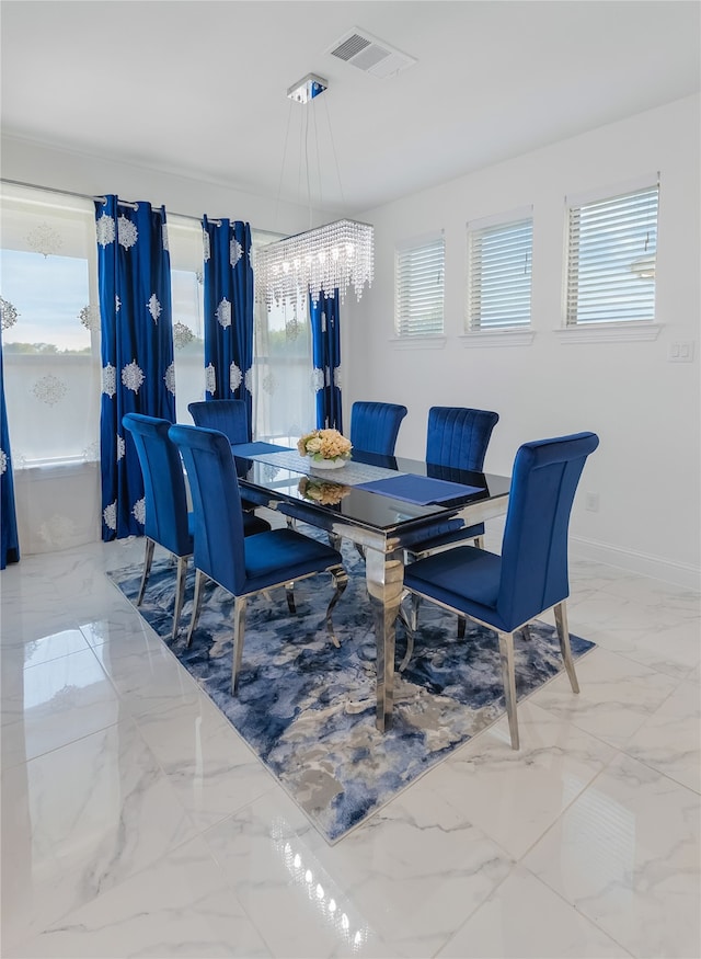 dining space featuring a notable chandelier