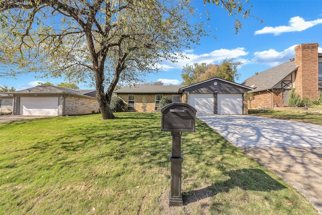 view of front of property with a garage and a front lawn