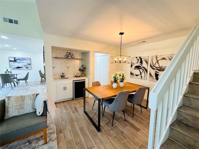 dining space with sink and a chandelier