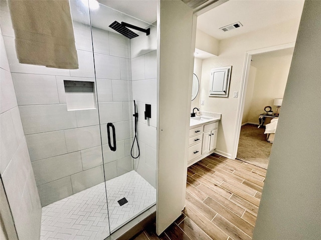 bathroom featuring vanity and an enclosed shower