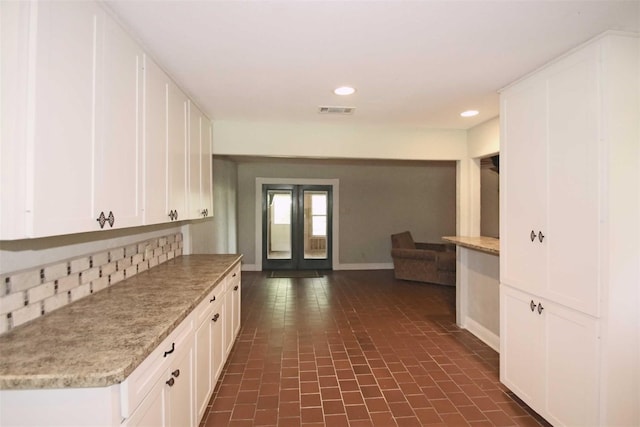 kitchen with white cabinets and dark tile patterned floors