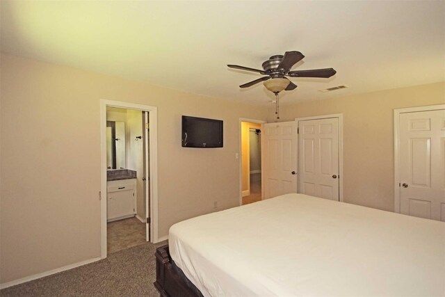 carpeted bedroom featuring ensuite bathroom and ceiling fan