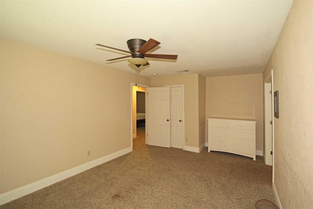 spare room with ceiling fan and carpet floors