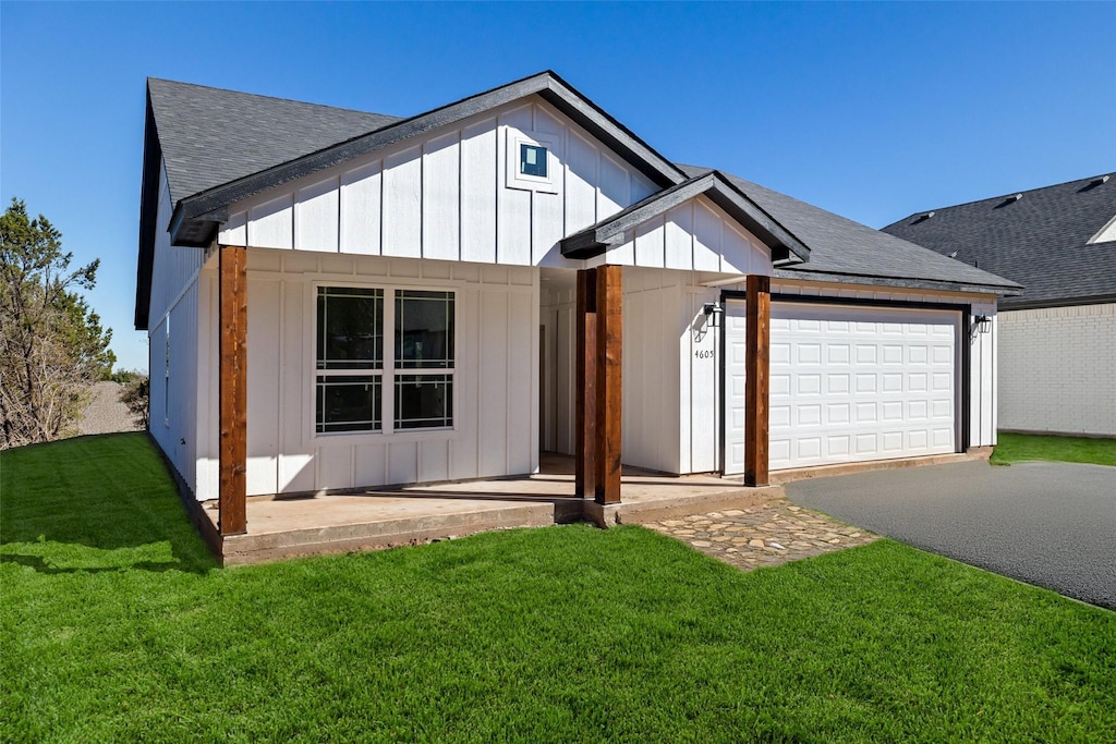 view of front of house with a garage and a front lawn