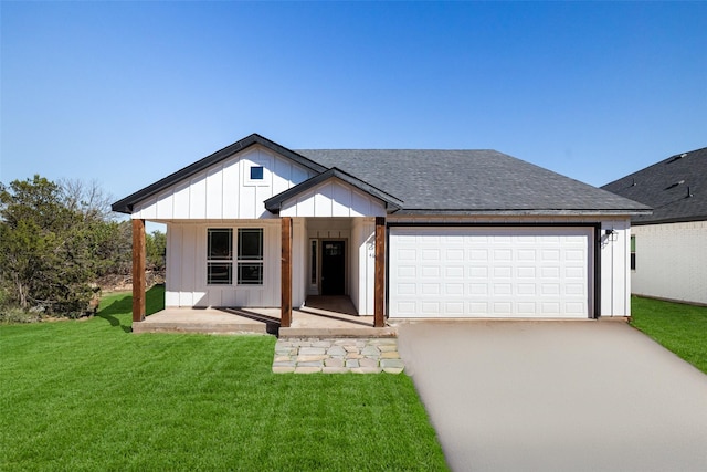 modern farmhouse featuring a front yard, a garage, and covered porch