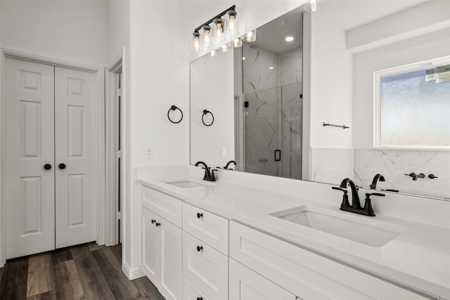 bathroom featuring hardwood / wood-style flooring, vanity, and walk in shower