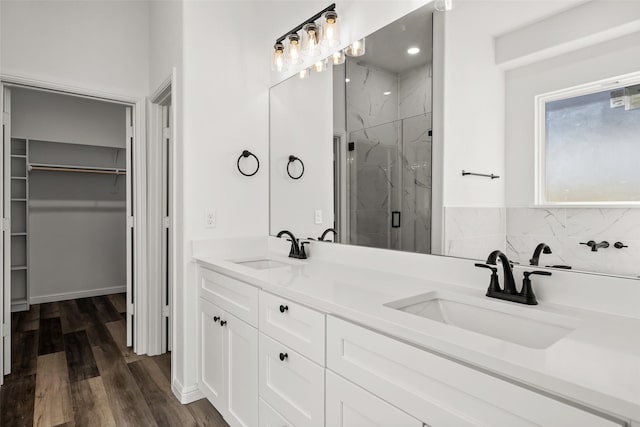 bathroom with vanity, hardwood / wood-style flooring, and a shower with shower door