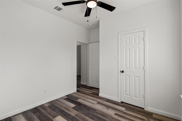 unfurnished bedroom with ceiling fan and dark hardwood / wood-style flooring