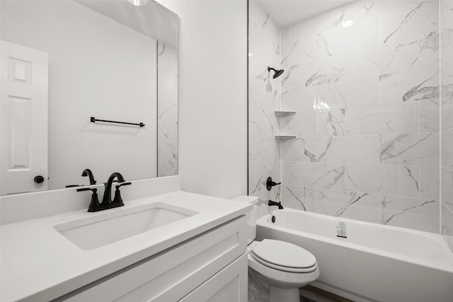 full bathroom with vanity, tiled shower / bath combo, and toilet