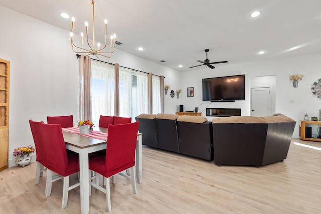 dining space with ceiling fan and light hardwood / wood-style floors