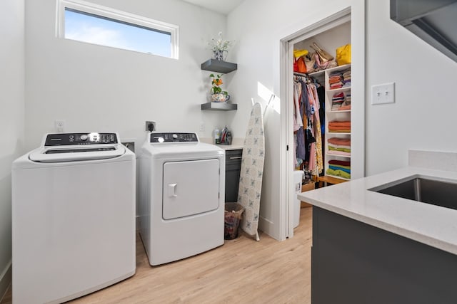 washroom featuring separate washer and dryer and light wood-type flooring