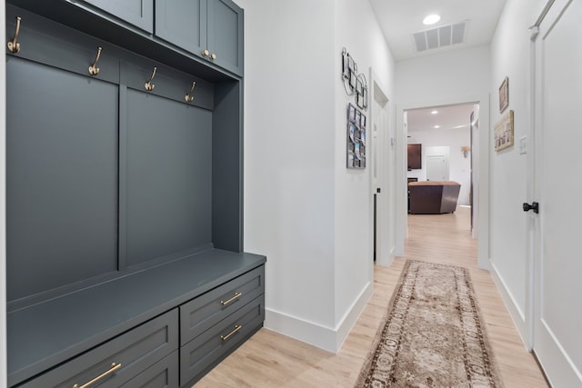 mudroom with light hardwood / wood-style floors