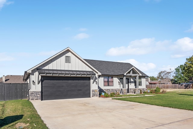 view of front of home with a garage and a front yard