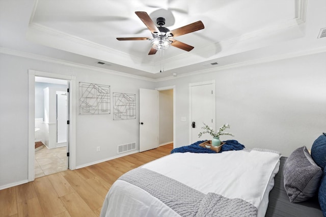 bedroom with a raised ceiling, ornamental molding, ceiling fan, and light hardwood / wood-style floors