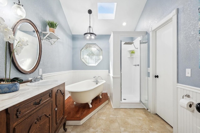 bathroom with tile patterned floors, vanity, lofted ceiling with skylight, and independent shower and bath