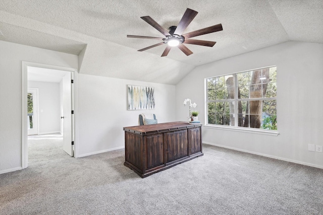 office with ceiling fan, lofted ceiling, carpet, and a textured ceiling