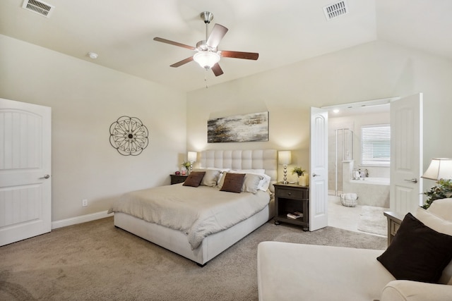 bedroom with connected bathroom, ceiling fan, light colored carpet, and lofted ceiling