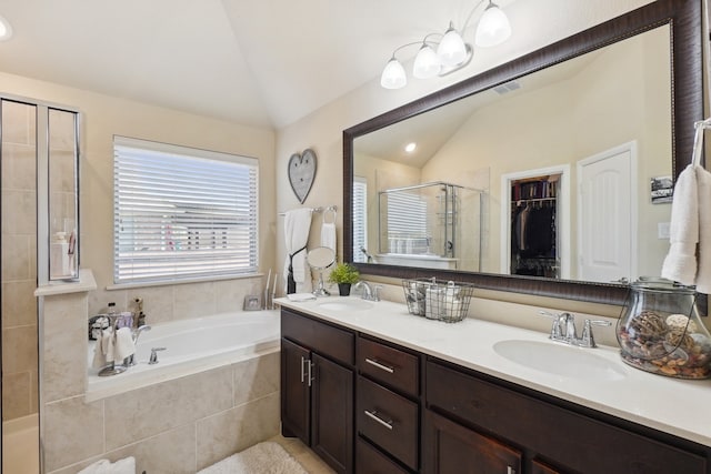 bathroom featuring vanity, lofted ceiling, and independent shower and bath