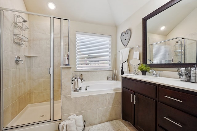 bathroom with vanity, separate shower and tub, and lofted ceiling