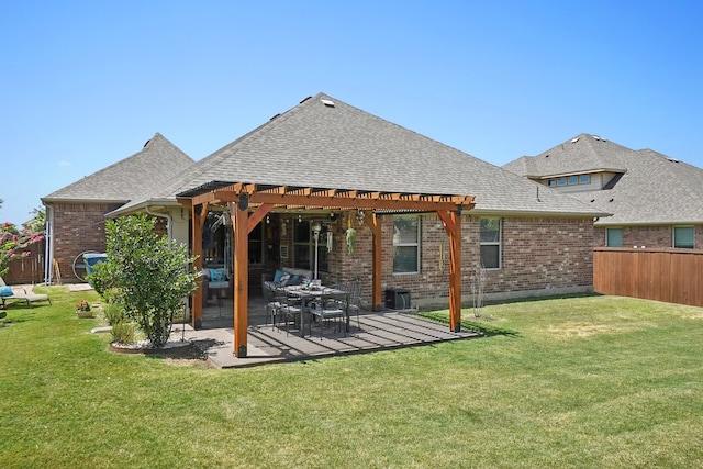 rear view of property featuring a pergola, a patio area, and a lawn