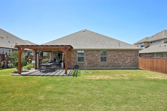 back of house with a pergola, a lawn, and a patio