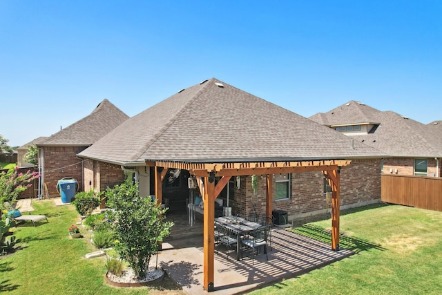 rear view of house with a lawn, a pergola, and a patio