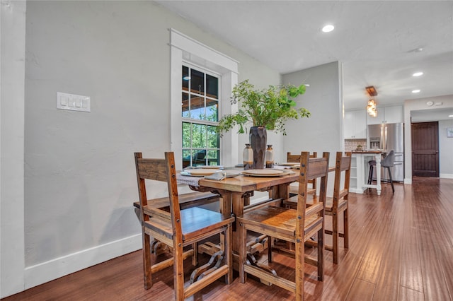 dining space featuring recessed lighting, wood finished floors, and baseboards