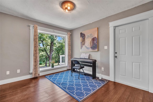 entrance foyer featuring hardwood / wood-style flooring and baseboards