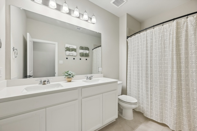 bathroom with tile patterned floors, vanity, and toilet