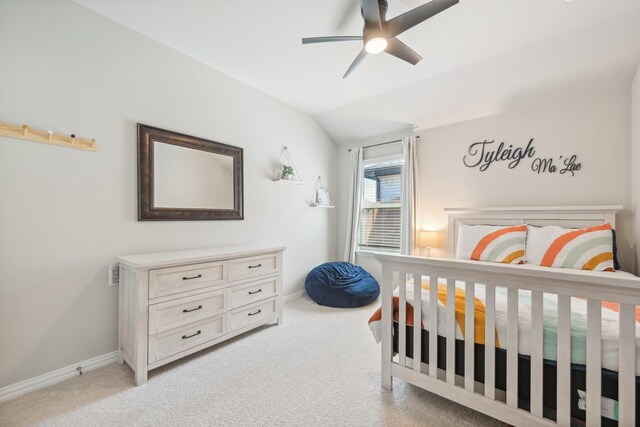 carpeted bedroom with vaulted ceiling and ceiling fan