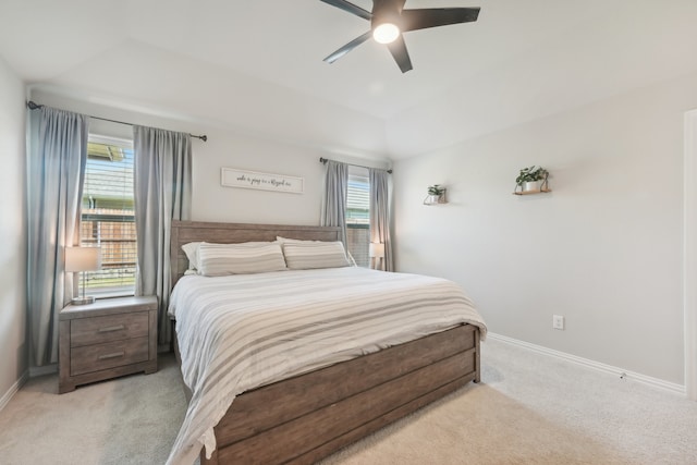 carpeted bedroom with multiple windows and ceiling fan