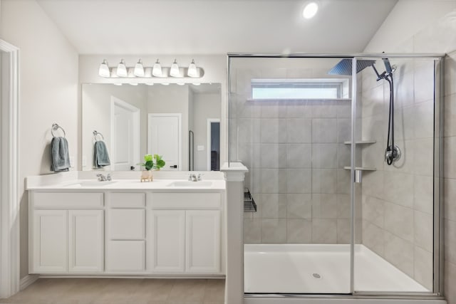 bathroom featuring tile patterned floors, vanity, vaulted ceiling, and a shower with door