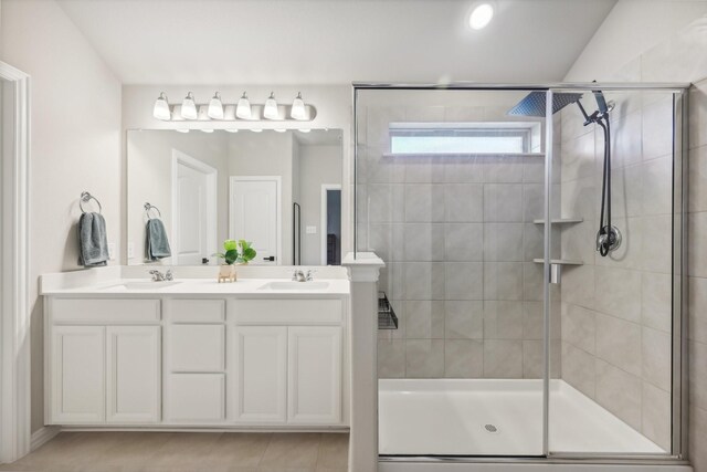 bathroom with vanity and a shower with door